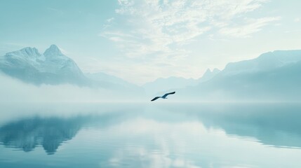 Fototapeta premium Serene Misty Mountain Lake with Bird in Flight