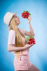 Young woman holding radish