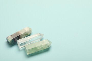 Beautiful natural gemstones on light blue background. Space for text