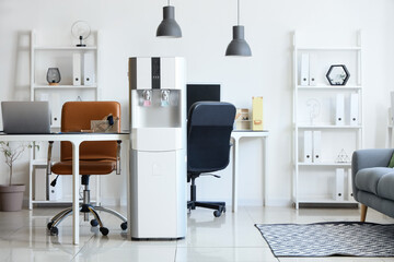 Interior of modern office with workplace, shelf units and water cooler