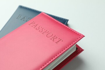 Passports in color covers on light background, closeup