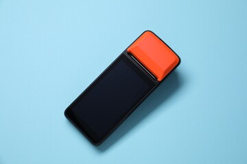 One payment terminal on light blue background, top view