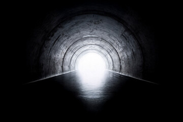 Black and white photograph of a highway tunnel viewed from the inside, highlighting depth and perspective.