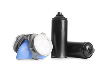 Spray paint cans and respirator on white background