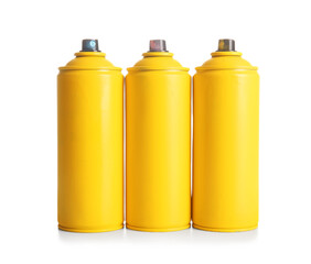 Spray paint cans on white background