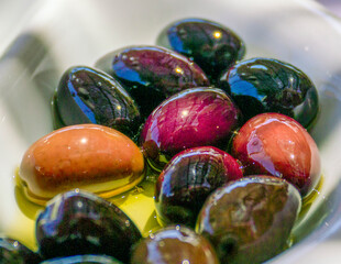 Warm colors of olives in olive oil.