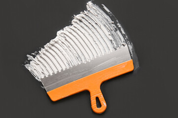 Knife with putty on black background