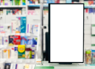 Pharmacy store. Blank empty white display panel advertising sign against blurred shelves in medical shop. Drugstore sales pills, vaccines and health care products