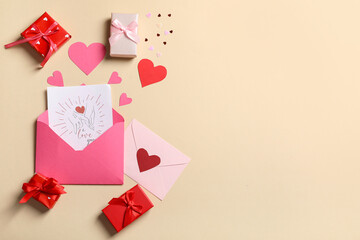 Envelopes with gift card, boxes and paper hearts on beige background. Valentine's day celebration