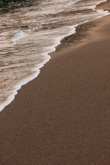 The wave breaks on the shore. White sea foam silhouette