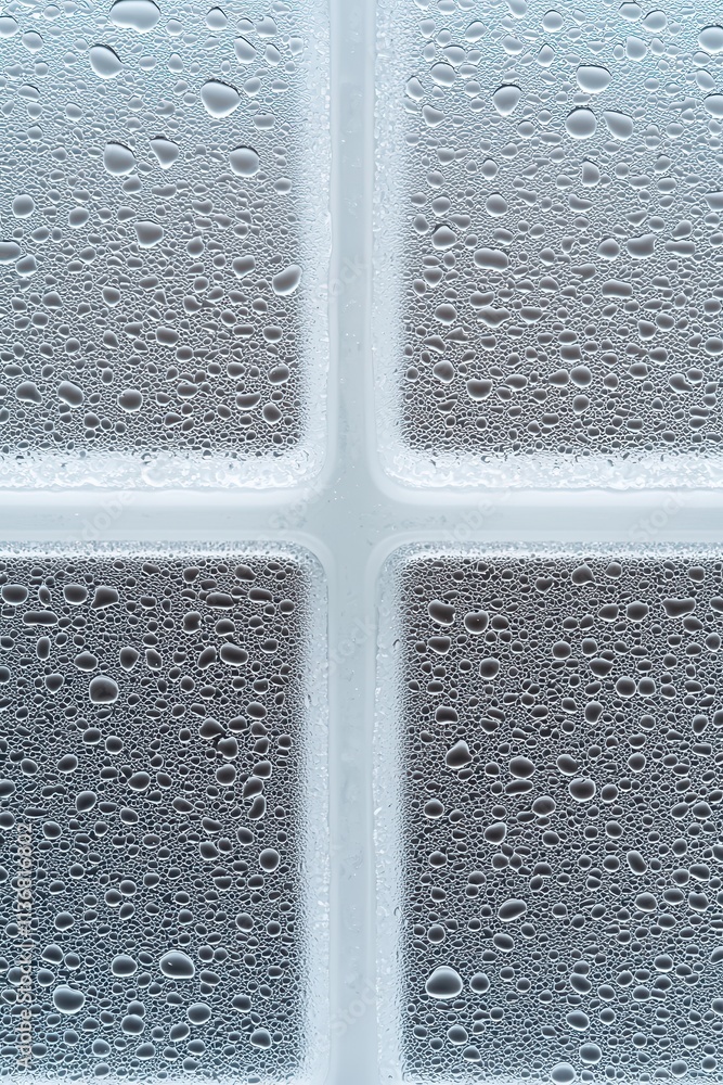 Poster a close-up view of condensation forming on a frosted surface, with droplets creating a textured patt