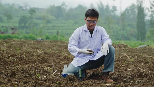 Junior Scientist in Agricultural Field, Analyzing Soil Health and Fertility, Holding Soil in Hand for Controlling and Checking Quality of The Soil Before Planting Season.