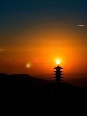Silhouetted Pagoda Against a Stunning Sunset