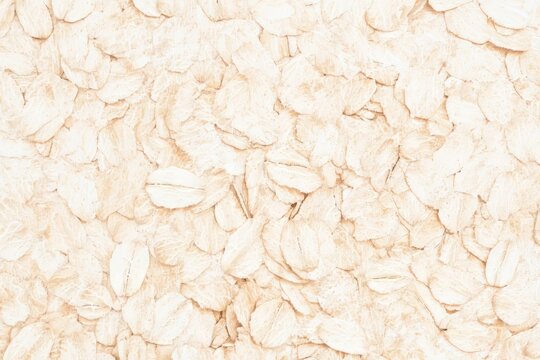Oatmeal texture pattern showcasing the natural appearance and color of rolled oats for culinary uses