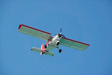 A light-engine tourist airplane in the blue sky. Copy space