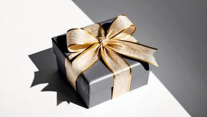 Photo of a gift box with a luxurious gold ribbon neatly wrapped. placed on a white background
