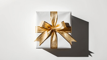 Photo of a gift box with a luxurious gold ribbon neatly wrapped. placed on a white background