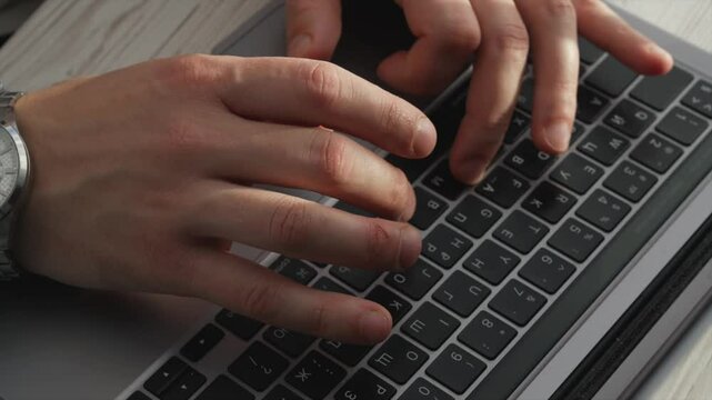 The chat operator is typing text on a laptop.
A man works at a laptop.
A person is surfing the Internet.
A man types text on a keyboard.
A copywriter works in the office at the computer.