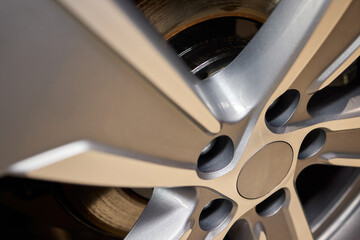 Detailed shot of a sleek black and silver alloy wheel on a motor vehicle