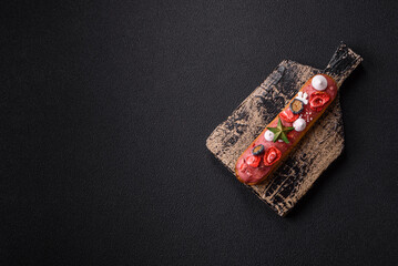 Sweet eclair with chocolate filling, decorated for Christmas