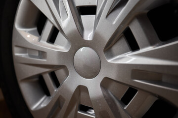 Detailed shot of a sleek black and silver alloy wheel on a motor vehicle