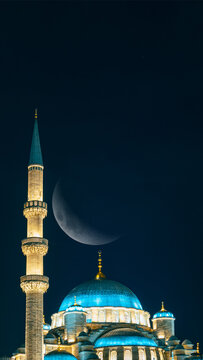 Eminonu New Mosque and crescent moon. Ramadan or islamic concept vertical photo