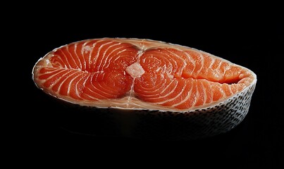 Raw Salmon Steak Isolated on Black Background