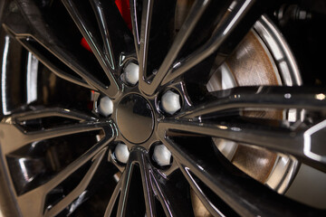 Detailed shot of a sleek black and silver alloy wheel on a motor vehicle