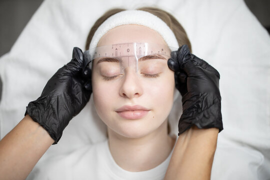 In a beauty salon, woman are pampered with a permanent makeup procedure. Skilled hands apply precise techniques to enhance natural features during this rejuvenating session.
