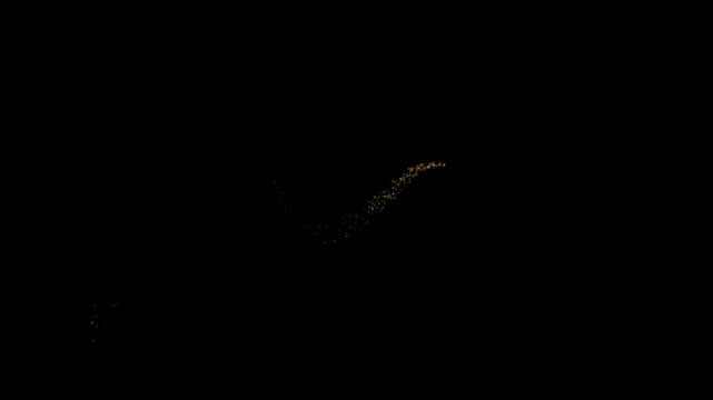 Collection of glowing golden stardust trails with star particles. Isolated on a black background with an alpha channel.