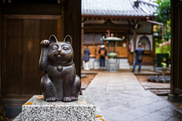 Gotokuji Temple: Tokyo's Birthplace of Maneki Neko 'Lucky Cat' Shinto Shrine for good fortune and Cat Lovers. Porcelain figure and temple details