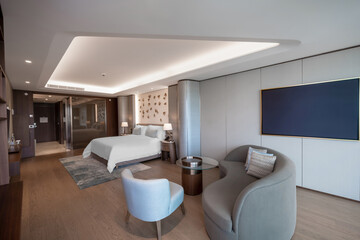 Modern hotel room with a bright and airy feel, a luxury hotel room. Example of a hotel room, modern furnishings and architecture.