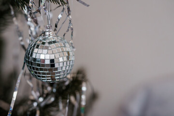 Shimmering Disco Ball Ornament Hanging on Christmas Tree