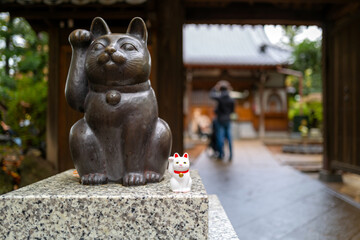 Gotokuji Temple: Tokyo's Birthplace of Maneki Neko 'Lucky Cat' Shinto Shrine for good fortune and Cat Lovers. Porcelain figure and temple details