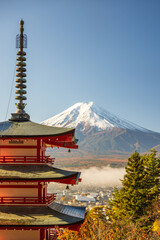 Mount Fuji, Japan - November 22 2024: The famous fuji mountain in during clear morning daylight with red autumn japanese maple leaves and no clouds. beautiful scenery from chureito pagoda famous place