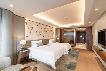 Modern hotel room with a bright and airy feel, a luxury hotel room. Example of a hotel room, modern furnishings and architecture.