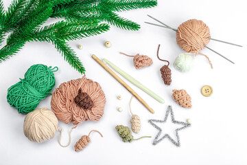 Creative handmade winter flat lay. Cozy crocheted pine cones, traditional decor, tools, craft mood