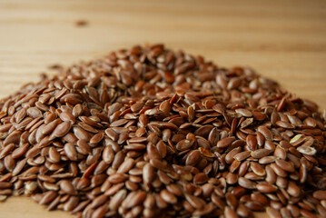 A close-up photo of flax seeds, highlighting their rich texture and natural shine.