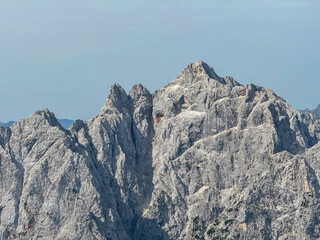 Panoramic view of rugged mountain ridge Prisank in majestic Julian Alps seen from top of summit...