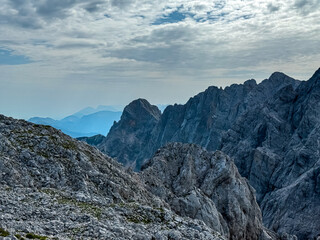 Panoramic view of rugged mountain ridge Skrlatica in majestic Julian Alps seen from top of summit...