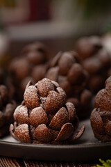 Christmas food dessert in the shape of brown pinecone on the plate  