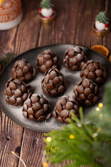 Christmas food dessert in the shape of brown pinecone on the plate  