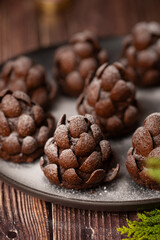 Christmas food dessert in the shape of brown pinecone on the plate  