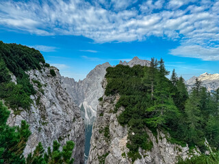 Jagged rock formation with scenic view of rugged mountain peak Prisank in majestic Julian Alps seen from Triglav National Park, Vrsic pass, Slovenia. Wanderlust wild Slovenian Alps. Sharp steep ridges