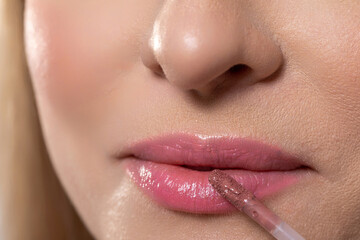 Fototapeta premium A closeup view of beautifully glossy lips featuring the meticulous application of lip gloss