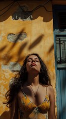 Fototapeta premium A Latin-American woman stands quietly in a colorful urban space, expressing deep grief amidst shadows and sunlight