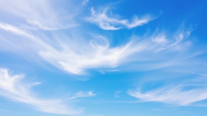 Fototapeta premium Beautiful white fluffy clouds floating across the clear blue sky on a sunny summer day, scenic, nature, tranquil