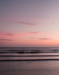 Naklejka premium Ocean Horizon at Sunset with Gentle Waves and Vibrant Sky