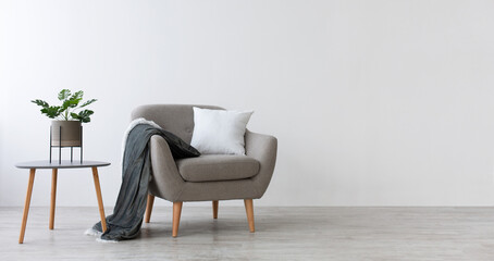 Ideas for modern minimal home interior design. Gray vintage armchair with white pillow and blanket,...