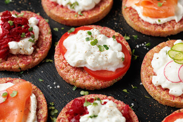 Lentil and pea protein veggie crispy cakes with cottage cheese, beetroot, tomatoes, radishes, cucumber and salmon